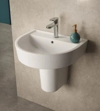 A semi pedestal basin attached to the wall of a modern chic bathroom suite.